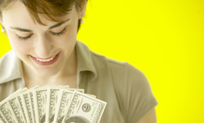 woman-holding-100-dollar-bills